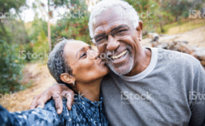 Husband and wife smiling and embracing.