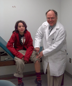 A patient gets his "knee-jerk" reflex tested at a CMT Center of Excellence.